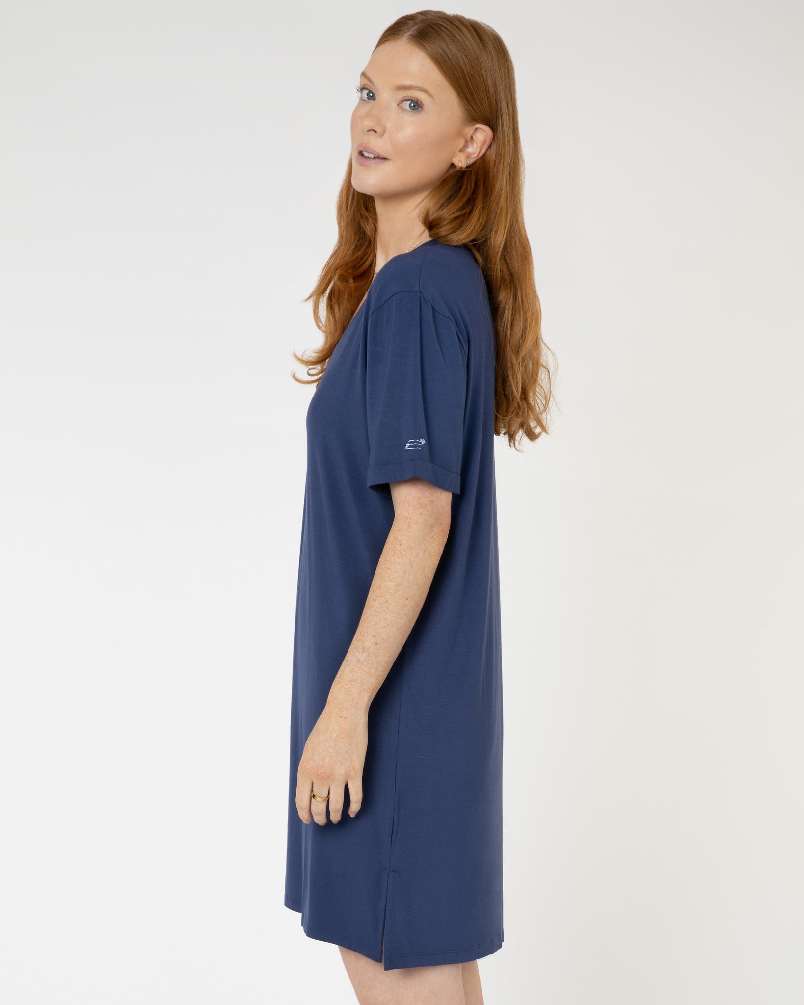 Woman wearing navy blue V-neck jersey nightdress made of micromodal fabric from Yawn.