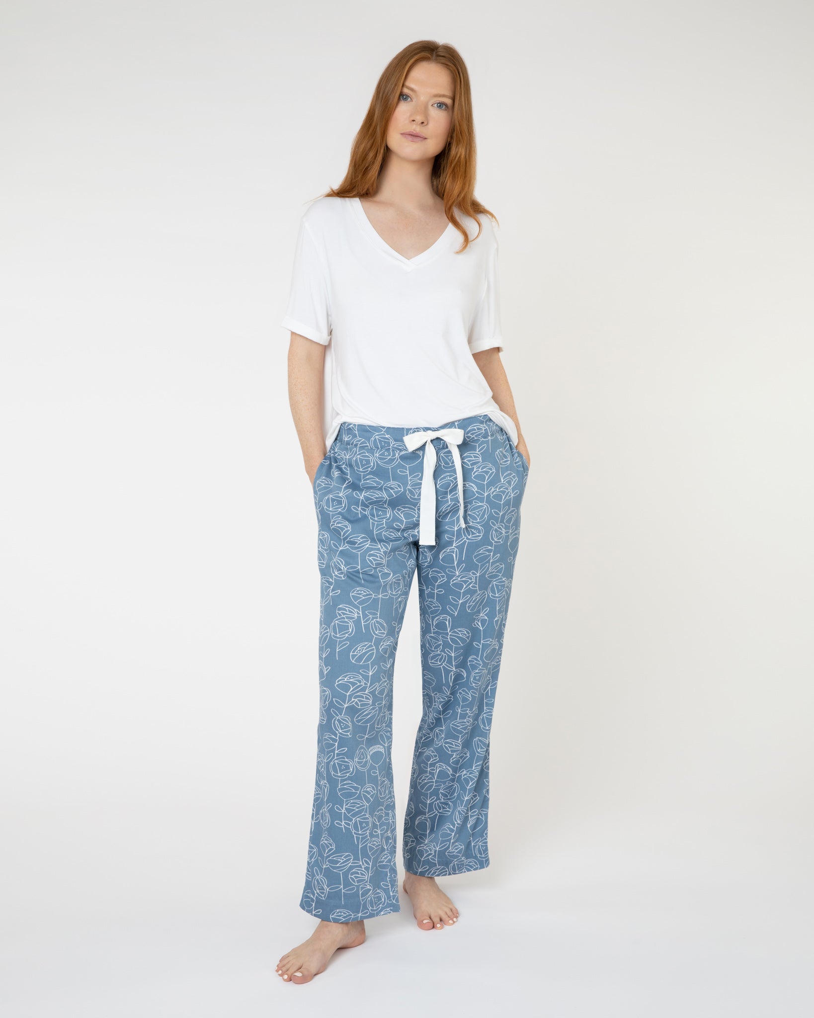 Woman wearing blue and white floral luxury organic cotton pyjama bottoms from Yawn.