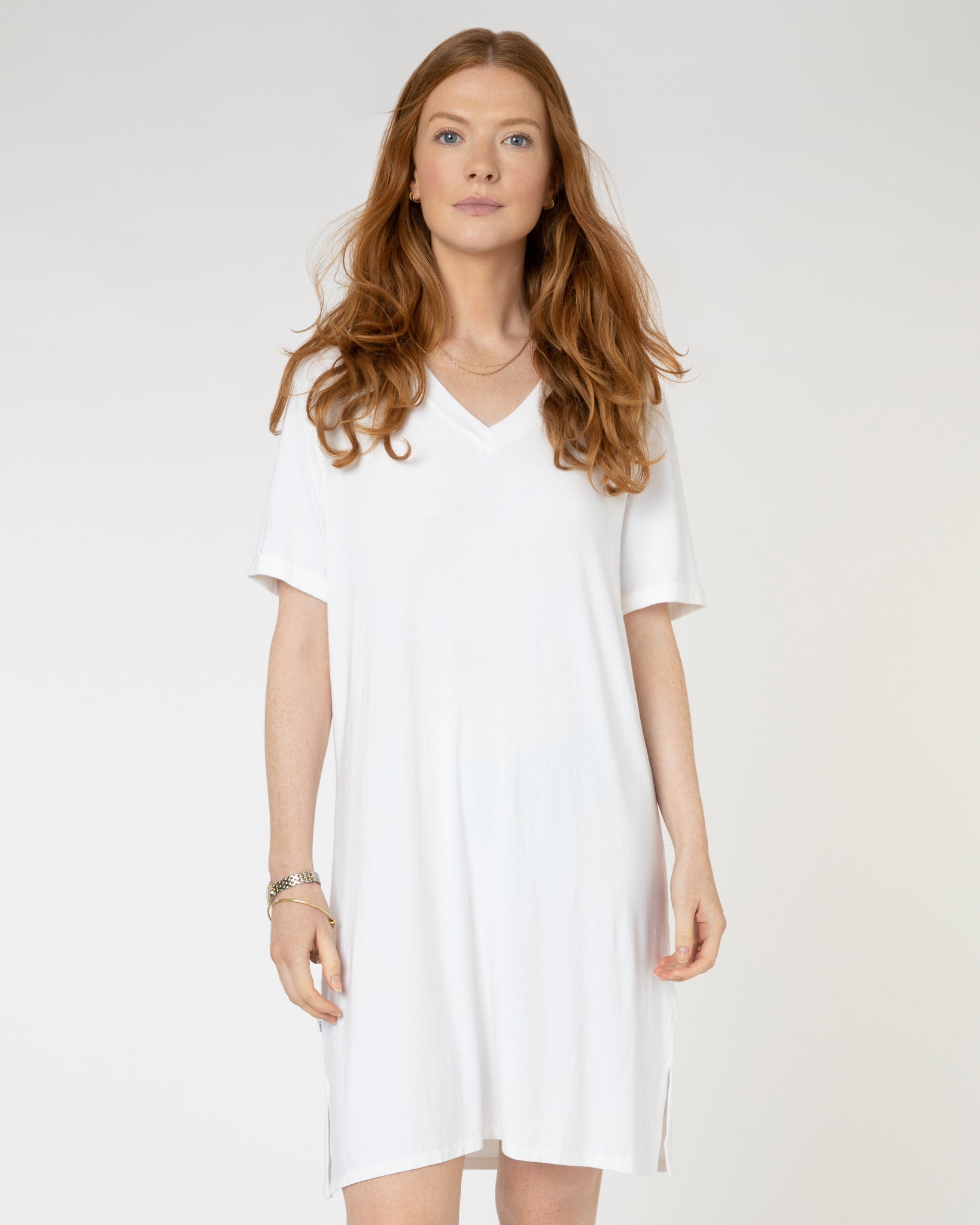 Woman wearing plain white V-neck jersey nightdress made of micromodal fabric from Yawn.
